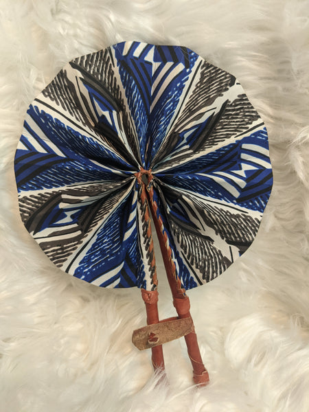 Colorful, cotton fabric and foldable mini fans. Handle made of leather with leather thong to hold together.