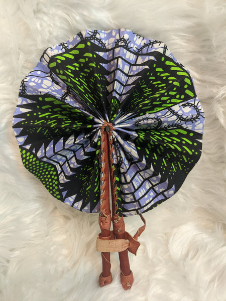 Colorful, cotton fabric and foldable mini fans. Handle made of leather with leather thong to hold together.